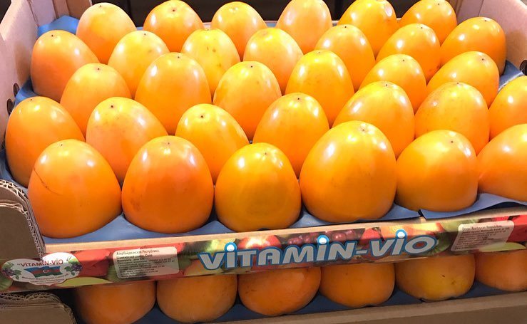 Persimmon close-up in branded packaging